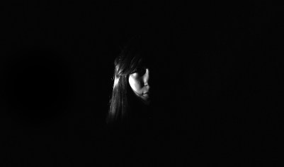 Using artifial lighting in a darkroom to experiment with portrait photography. Model - Miriam. 